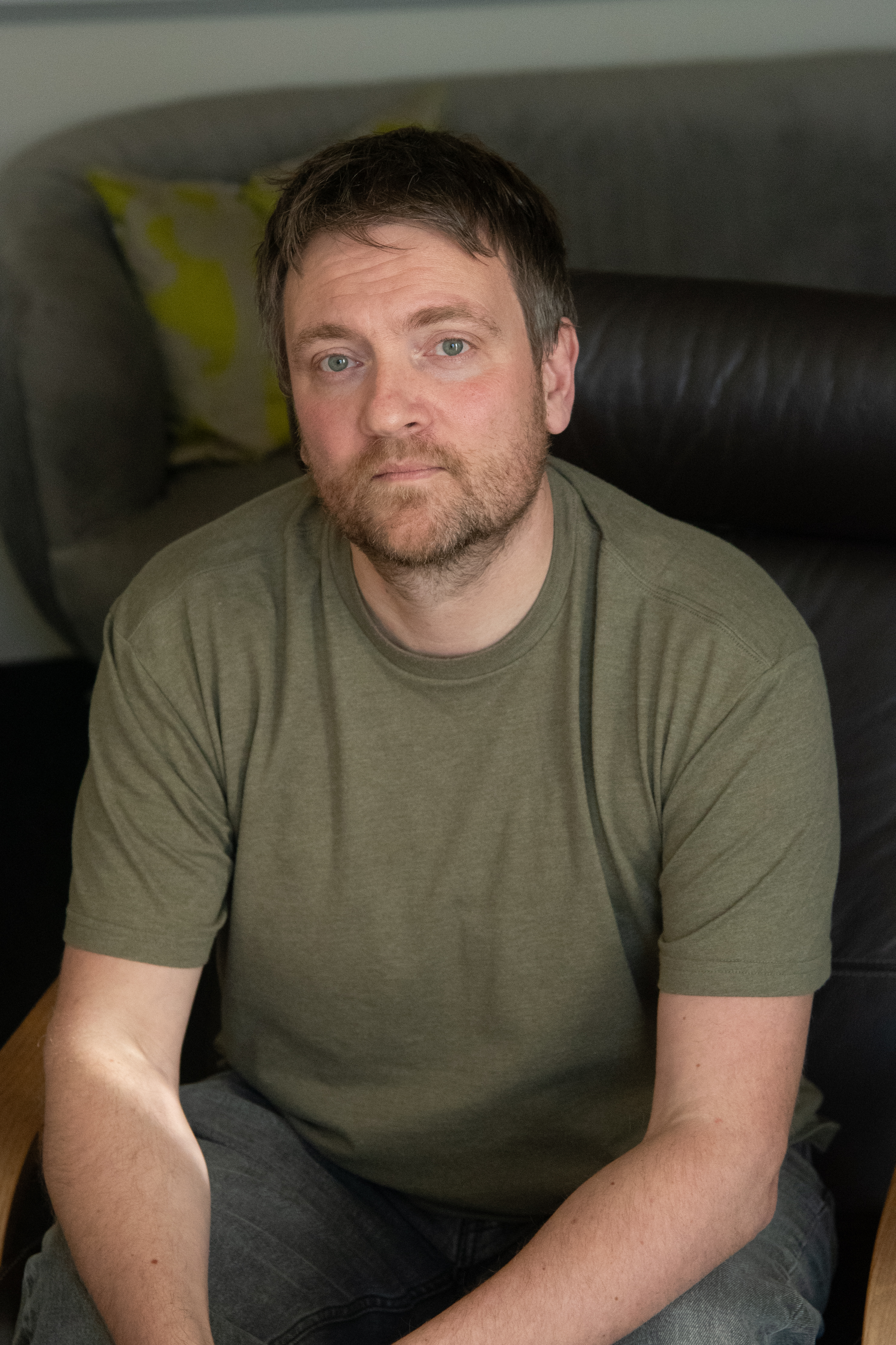 Tim headshot: short brown hair, beard, green t-shirt